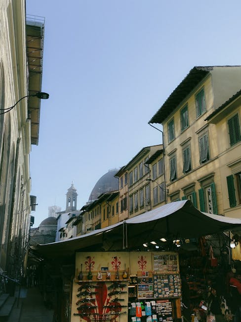 Historic European city street at dusk with market stalls