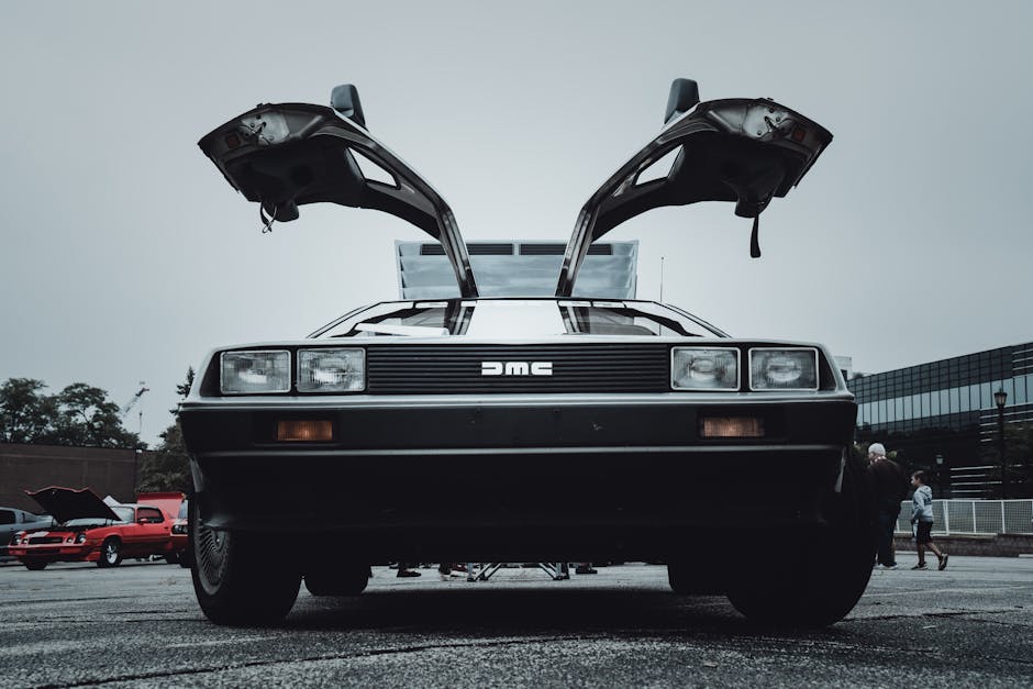 Classic silver DeLorean with gull-wing doors open representing luxury lifestyle